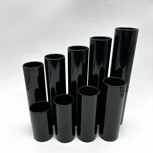 Set of black cylindrical vases on a white background