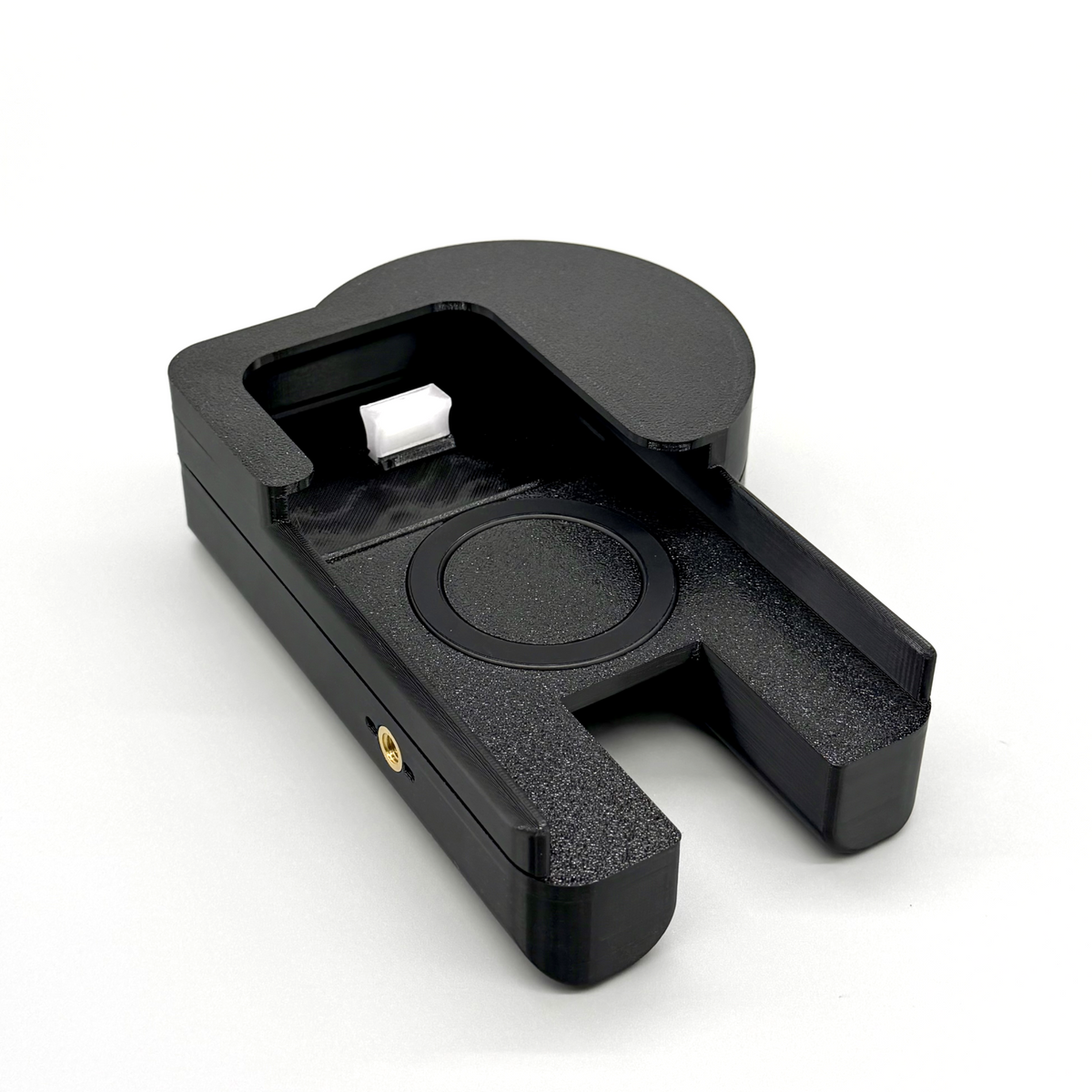 Porthole Creator Cradle for iPhone and Android. Black camera lens filter holder with an orange filter on a white background. Black camera lens cap holder on a white background