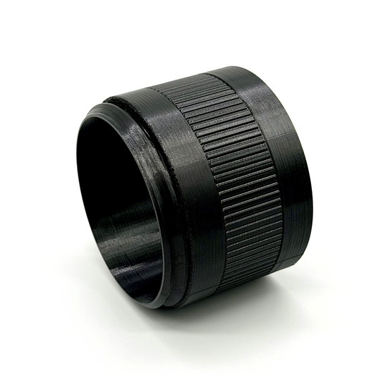 Porthole Mark II 2.5" Focal Tuning Extension. Black camera lens with ribbed design on a white background
