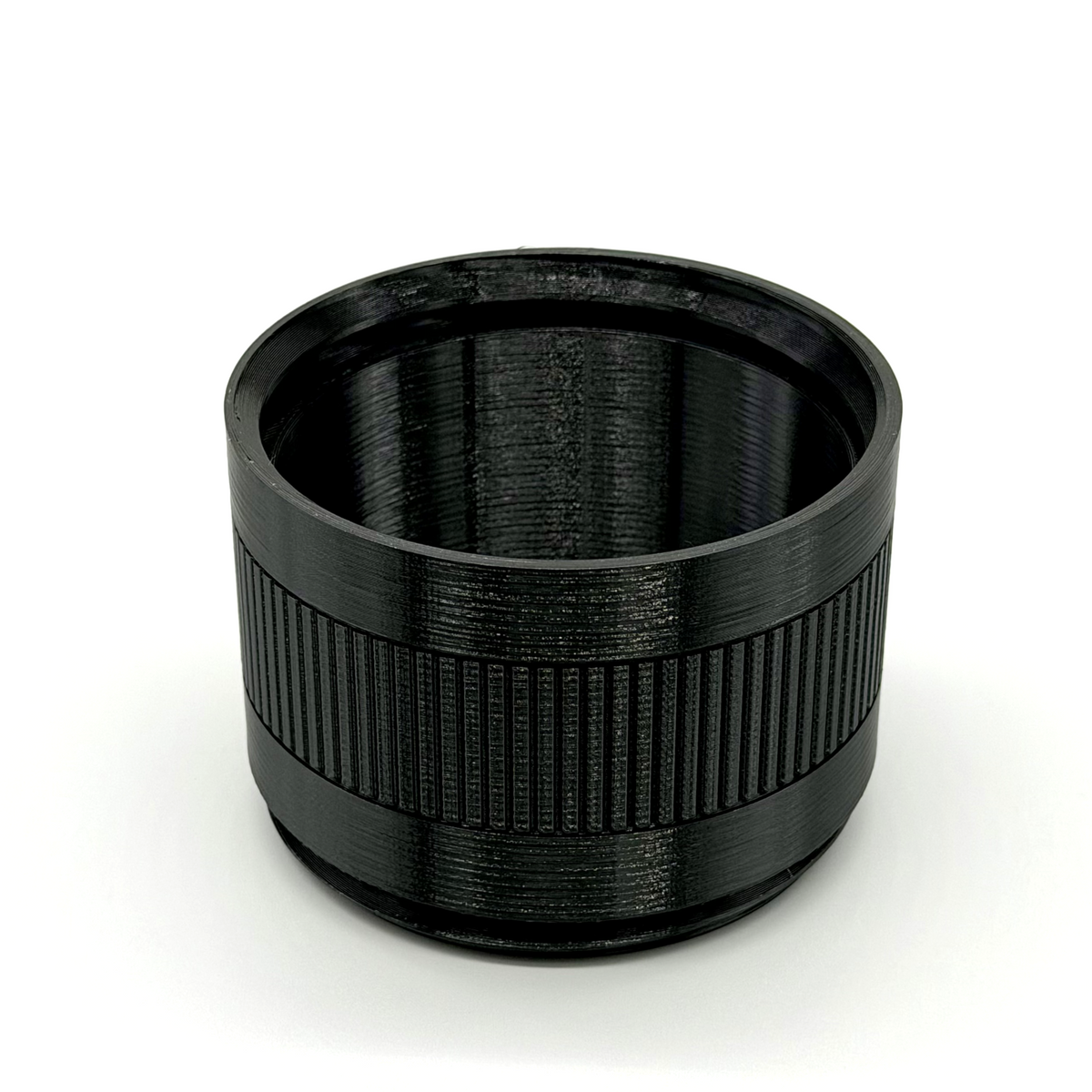 Black cylindrical lens hood on a white background. Porthole Mark II 2.5" Focal Tuning Extension.