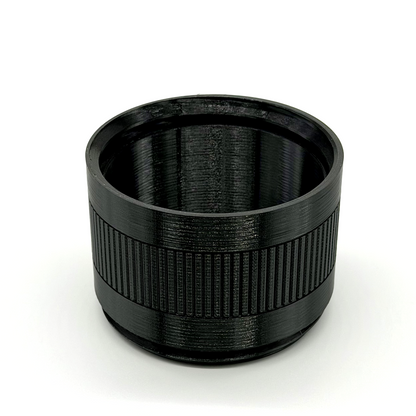 Black cylindrical lens hood on a white background. Porthole Mark II 2.5" Focal Tuning Extension.