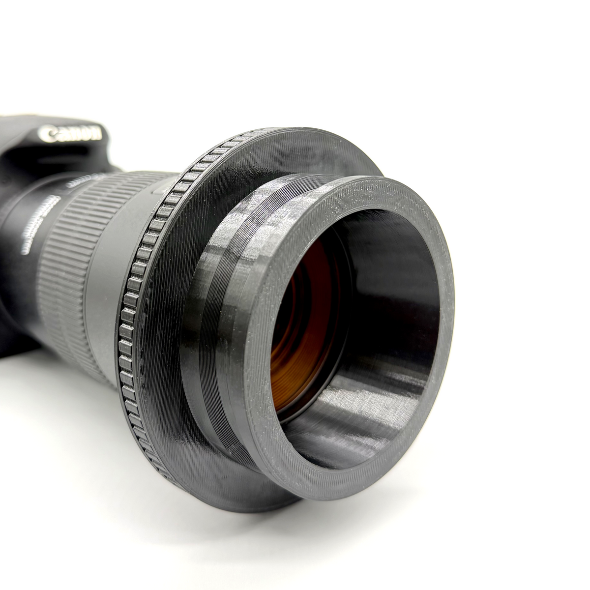 Close-up of the black Porthole Mark II Prime Interface. Camera lens adapter on a white background