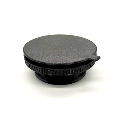 Porthole Mark II Prime Interface. Black camera lens cap on a white background
