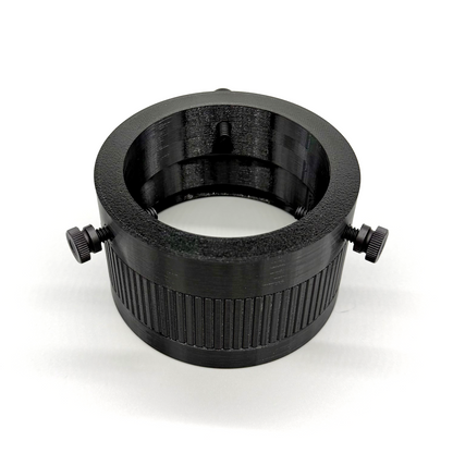 Black cylindrical lens or filter with threaded sides on a white background. Porthole Mark II Studio Upper Assembly